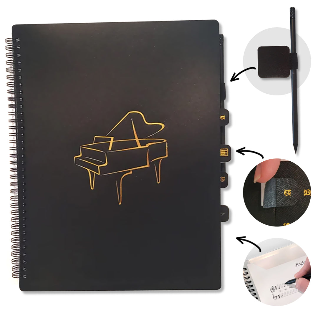 Black notebook with gold piano illustration, pen, and stickers on a white background