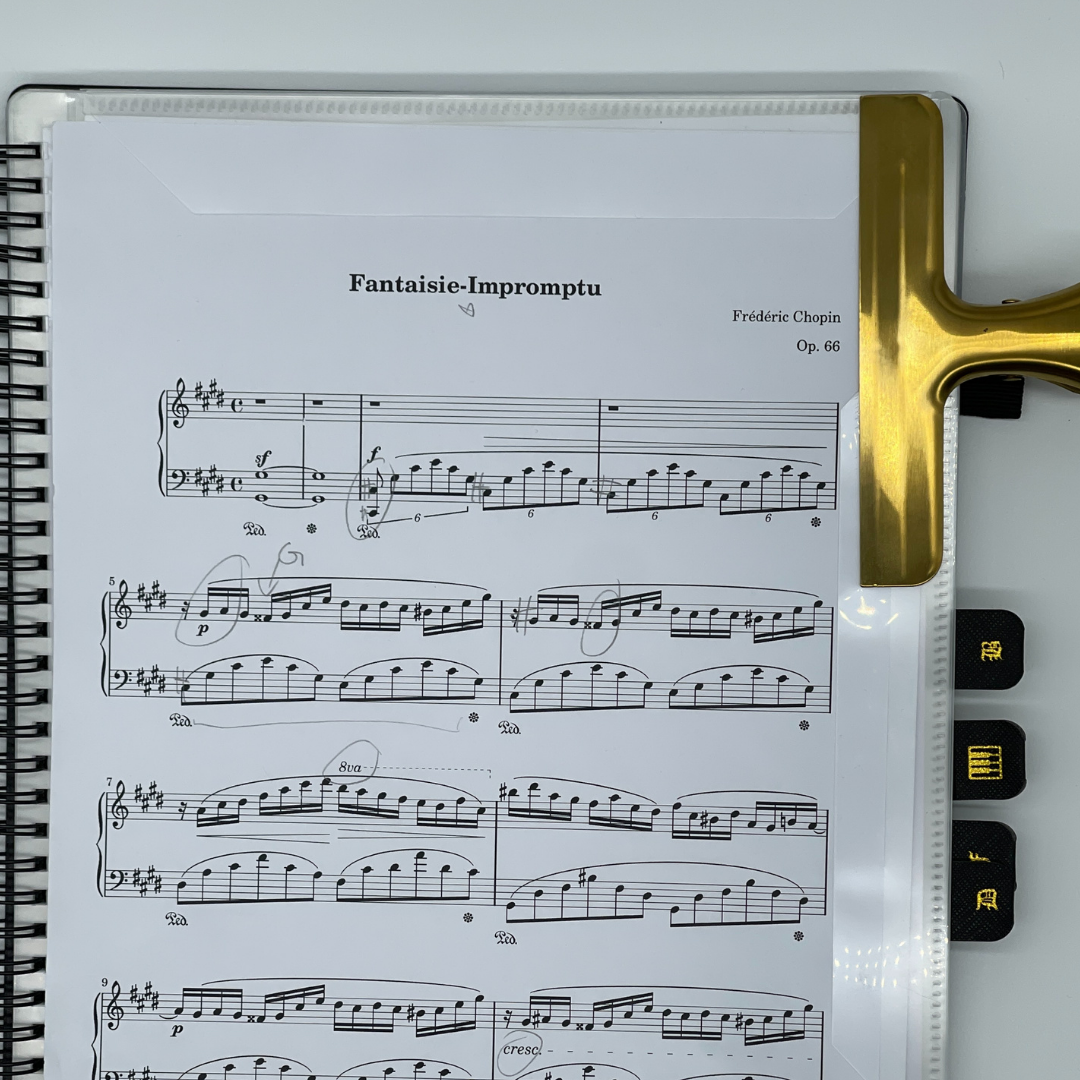 Gold stainless steel sheet music clip securely holding Fantaisie-Impromptu by Chopin on Piano Glory A4 Music Folder pack on the side — elegant, durable clip designed to keep sheet music in place during piano practice or performance
